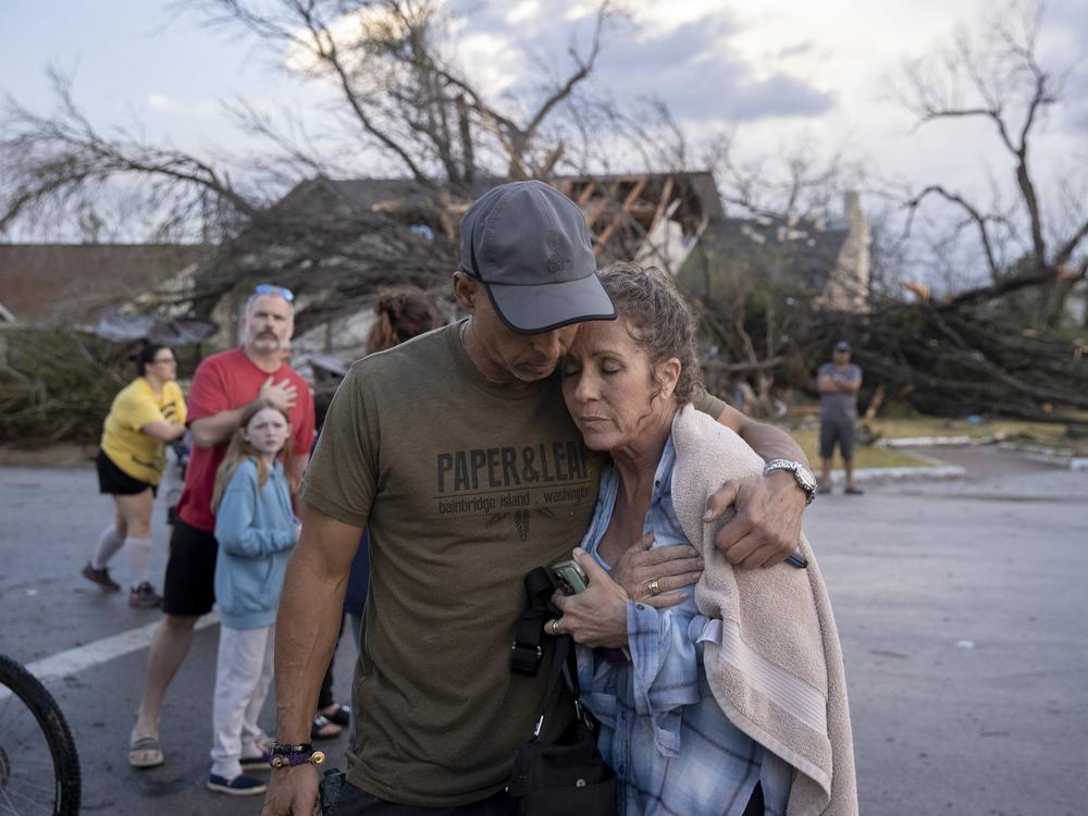 Michael Talamantez comforts his girlfriend Derry Schroer after Talamantez' house in Round Rock, Texas, was destroyed by a severe storm, reported as a tornado, while they were inside on Monday. 