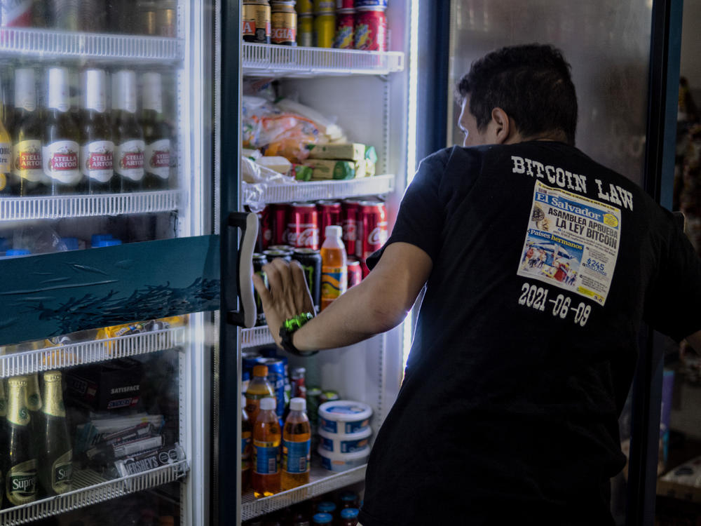 Santos Antonio Franco Valle, 23, wears a shirt commemorating the day the news came out about bitcoin becoming a legal tender of his country, El Salvador. He runs a convenience store in El Zonte.