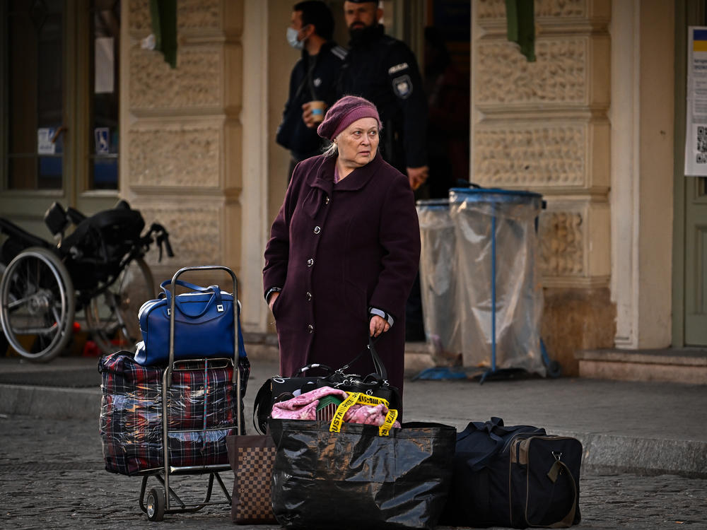 A woman waits for a bus at Przemysl train station in Polan after travelling on a train from war-torn Ukraine on March 22.