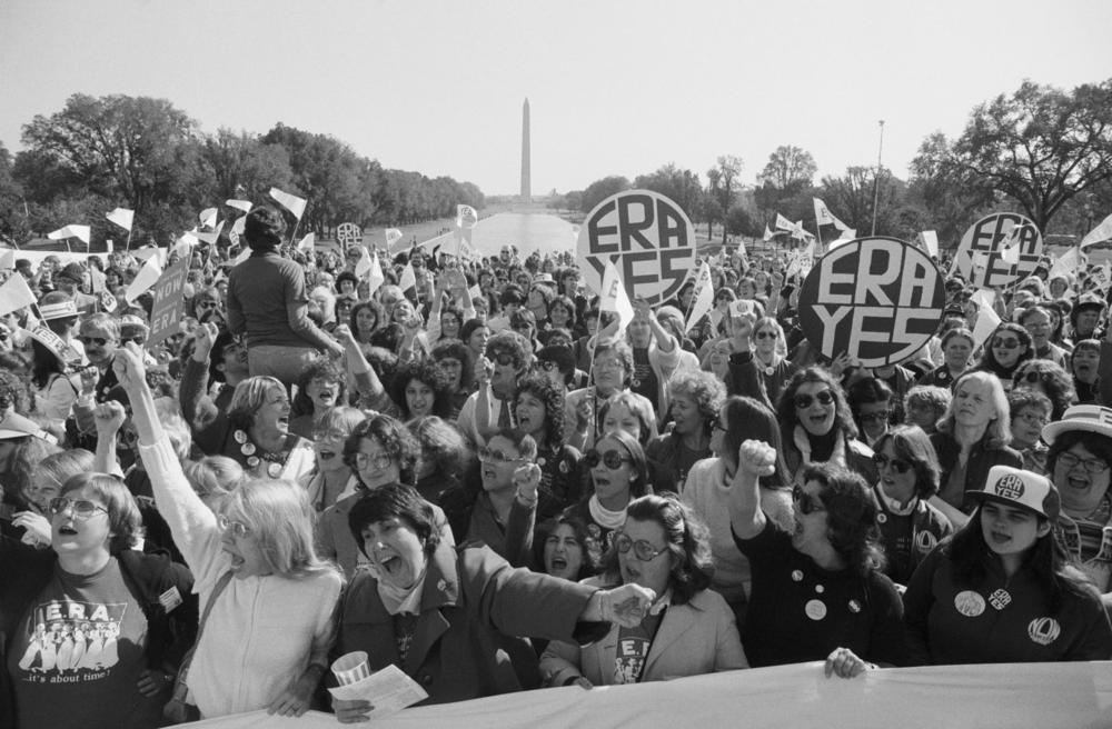 A large crowd of women cheers a speaker at the Lincoln Memorial, during a rally for passage of the Equal Rights Amendment.