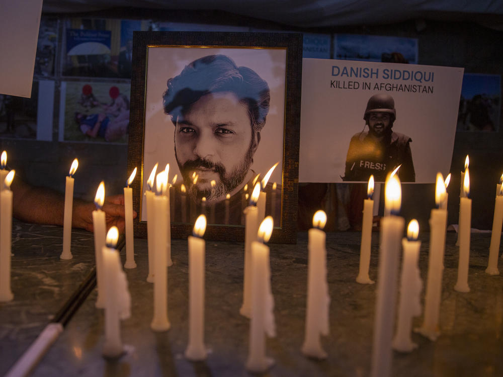 In this July 17, 2021, file photo, candles lit by journalists in New Delhi pay tribute to photojournalist Danish Siddiqui, who was killed in Afghanistan covering clashes between the Taliban and Afghan security forces.