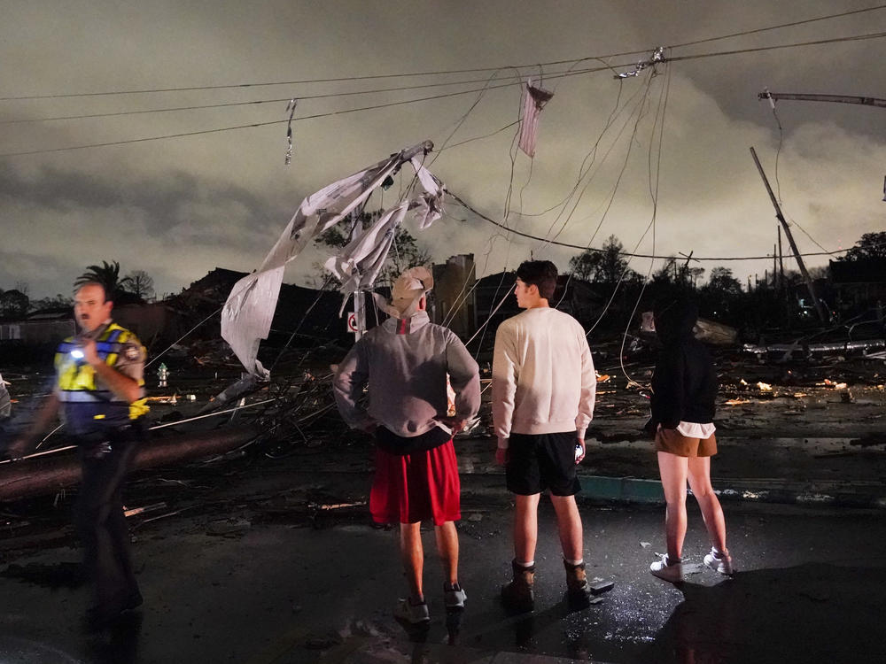 Authorities survey damage in the Lower 9th Ward on Tuesday in New Orleans.