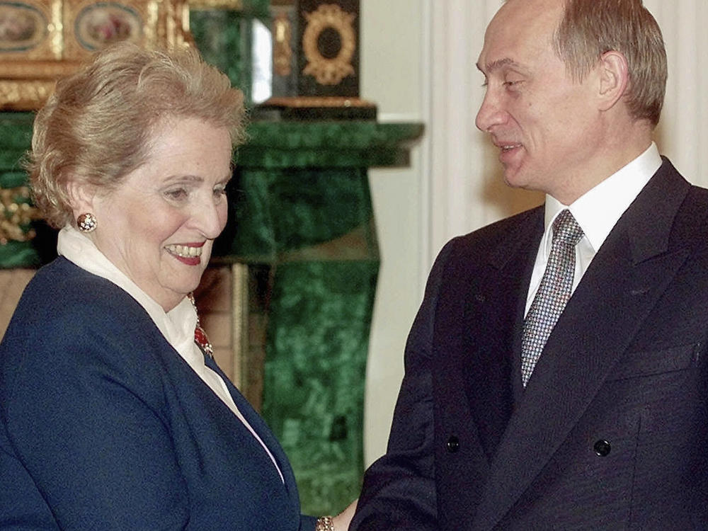 U.S. Secretary of State Madeleine Albright smiles as she shakes hands with Russian acting President Vladimir Putin, right, in Moscow's Kremlin, in 2000. Albright has died of cancer, her family said Wednesday.