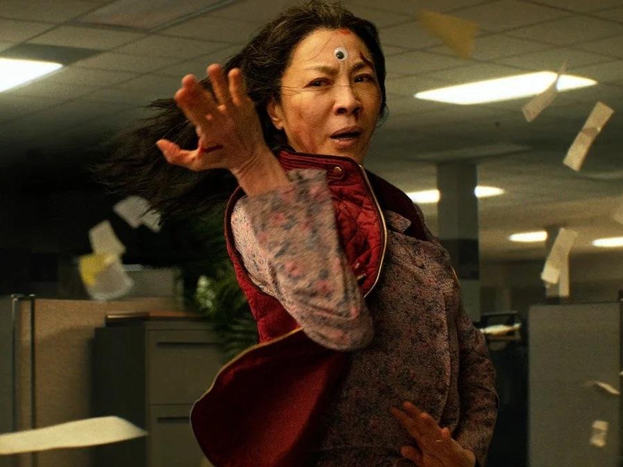 Michelle Yeoh stars as a woman who suddenly develops the power to leap between parallel universes in the action-adventure-fantasy <em>Everything Everywhere All at Once.</em>