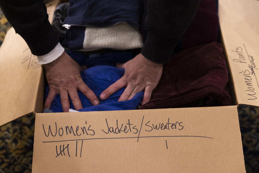 <strong>March 10:</strong> Jacob Hartenstein packs a box of donated clothing. St. Andrew Ukrainian Orthodox Cathedral in Silver Spring, Maryland receives donations in order to send much-needed supplies to Ukraine, such as clothing, allergy medication for children, trauma care supplies and mobility aids, like crutches.
