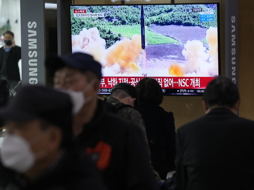 People watch a TV showing a file image of North Korea's missile launch during a news program at the Seoul Railway Station in Seoul, South Korea, on Thursday.