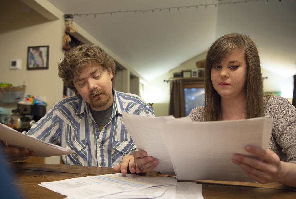 Sean and Rebekah Deines review his medical bills at their home in Hendersonville, N.C. Eventually, the insurance company dropped its attempt to get repayment.