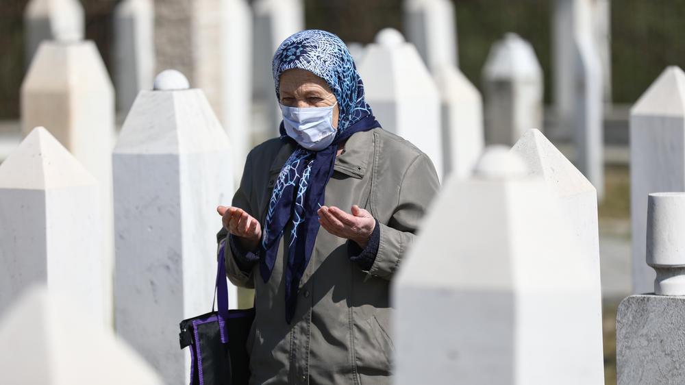 People pray at cemetery during a ceremony held the 28th anniversary of Ahmici massacre under COVID-19 measures in Vitez, Bosnia, and Herzegovina in April 2021. 116 Bosnian civilians were killed by Croatian Defence Council (HVO) during the Croat-Bosniak War in April 1993 in Ahmici village.