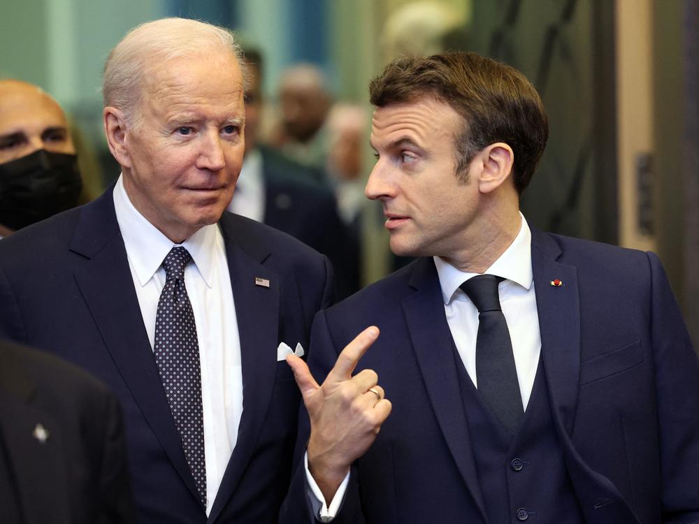 President Joe Biden (L) speaks with France's President Emmanuel Macron ahead of an extraordinary NATO summit at NATO headquarters in Brussels on Thursday.