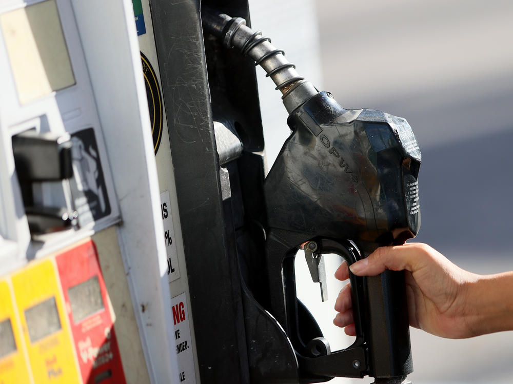 MIAMI, FLORIDA - NOVEMBER 22: Gabriela Chirinos places the handle back on the pump after filling her vehicle with gas at a Shell station on November 22, 2021 in Miami, Florida. Florida Governor Ron DeSantis announced he would ask state lawmakers to temporarily 