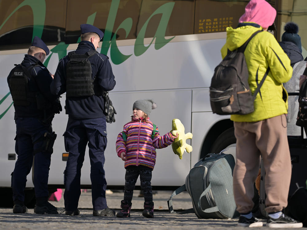 People pass through Przemysl station in Poland on their journey out of war-torn Ukraine on Thursday. One in four Ukrainians have been displaced from their homes in the past month.