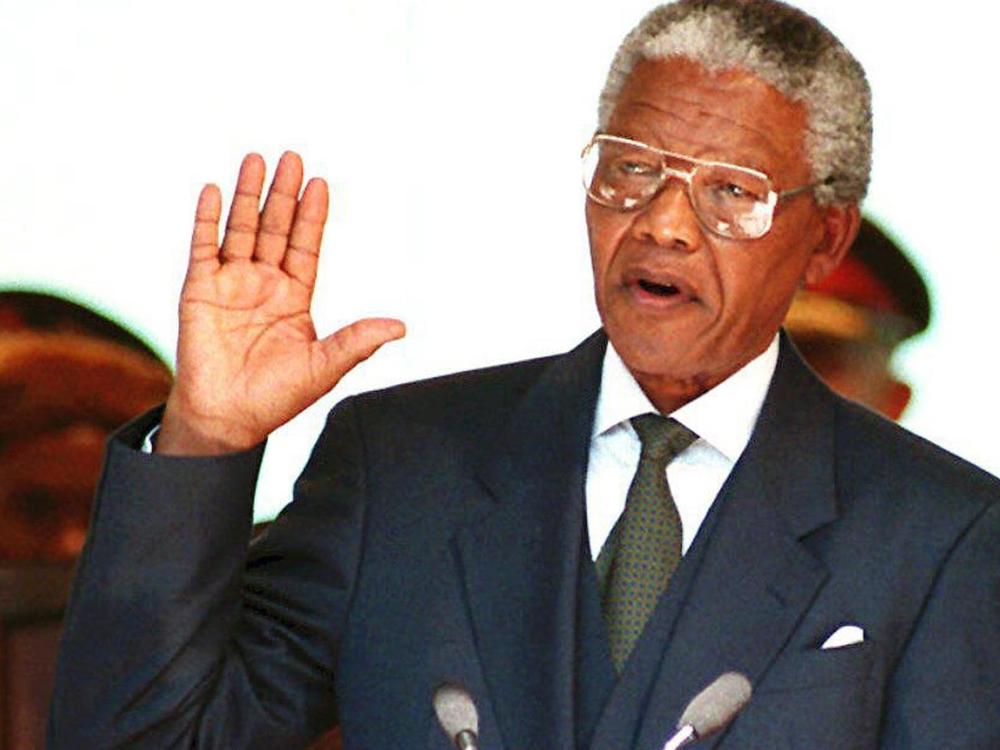 A file photo showing South African President Nelson Mandela taking the oath 10 May 1994 during his inauguration at the Union Building in Pretoria.
