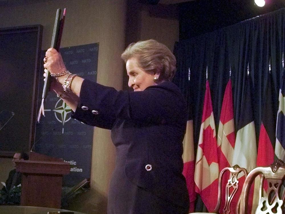 Secretary of State Madeleine Albright displays the instruments of accession that brought Hungary, Poland and the Czech Republic into NATO.