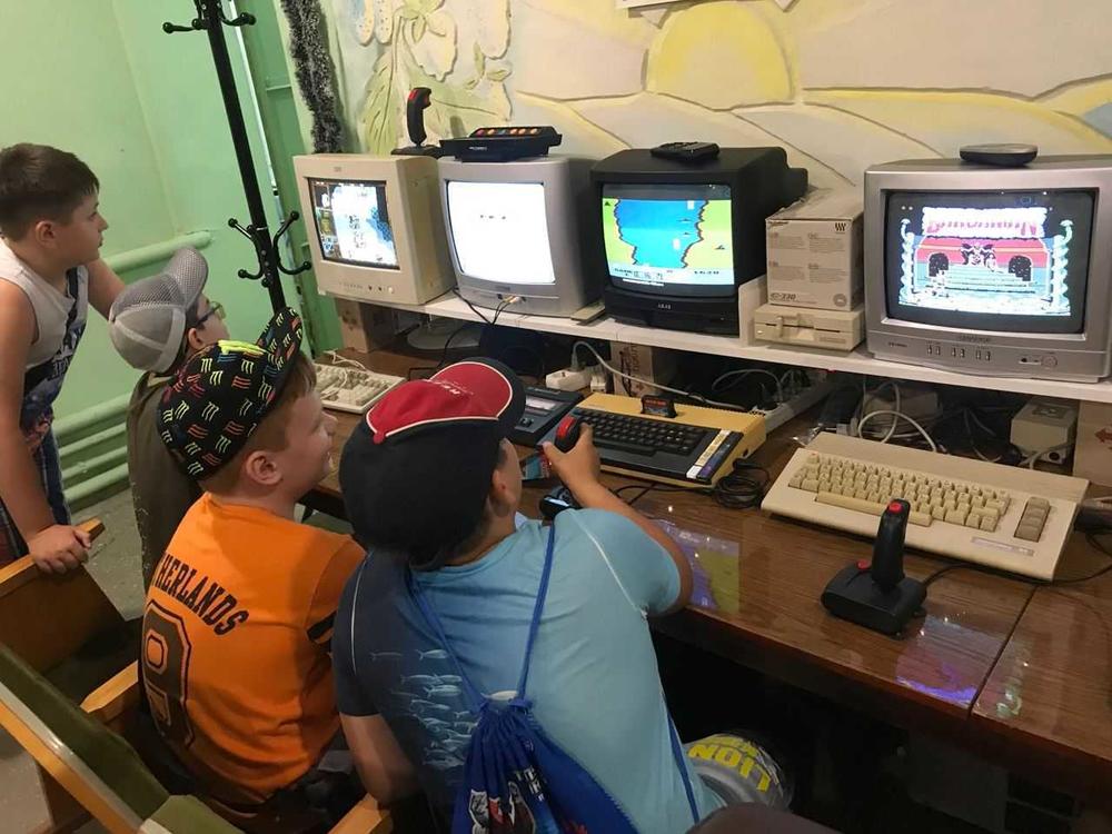 Kids play on retro computers in the IT 8-bit museum in Mariupol, Ukraine before it was attacked.