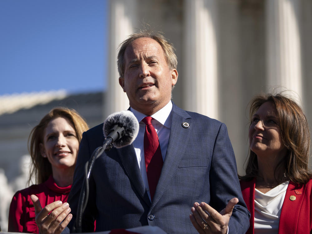 Texas Attorney General Ken Paxton says a weeklong celebration of Pride events in Austin schools this week violates state law. Here, he speaks outside the U.S. Supreme Court on Nov. 1.