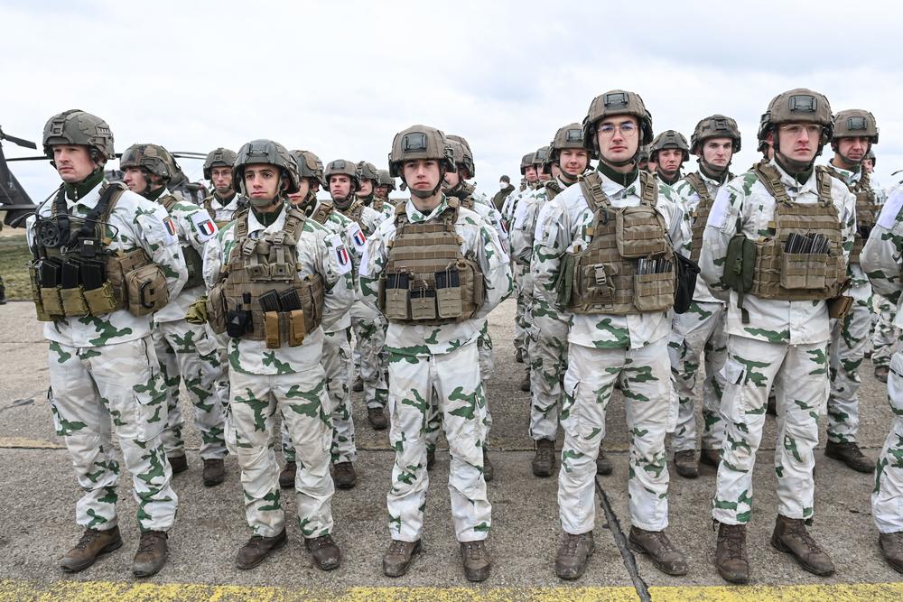 French army personnel stand during an official welcoming ceremony for the French defense minister at an air base in Romania on March 6.