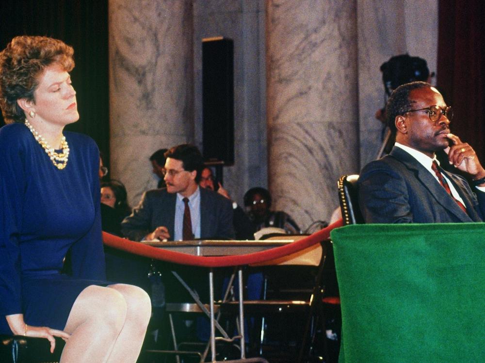 Supreme Court nominee Clarence Thomas is flanked by his wife Ginni during his confirmation hearings in 1991. Ginni Thomas requested law professor Anita Hill apologize for filing sexual harassment charges against her husband.
