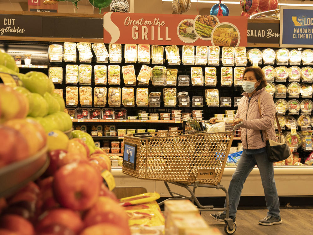 A woman shops for fruits at a supermarket on March 10, 2022 in San Mateo County, California.