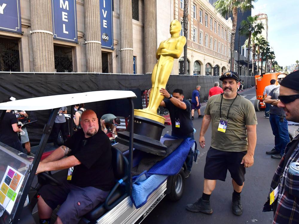 A statue of the Oscar is placed for transportation along Hollywood Boulevard as preparations for the red carpet arrivals area continued March 25.