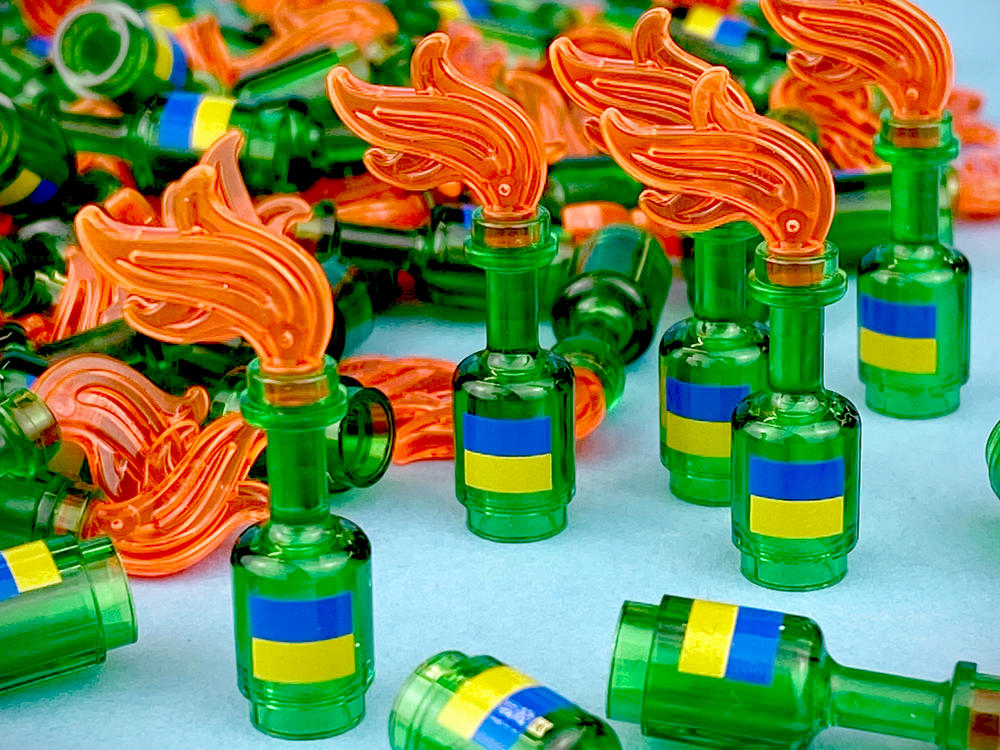 Mini figurines based on Molotov cocktails, featuring the Ukrainian flag sold for $20 each, with proceeds donated to a non-profit aid group, Direct Relief.