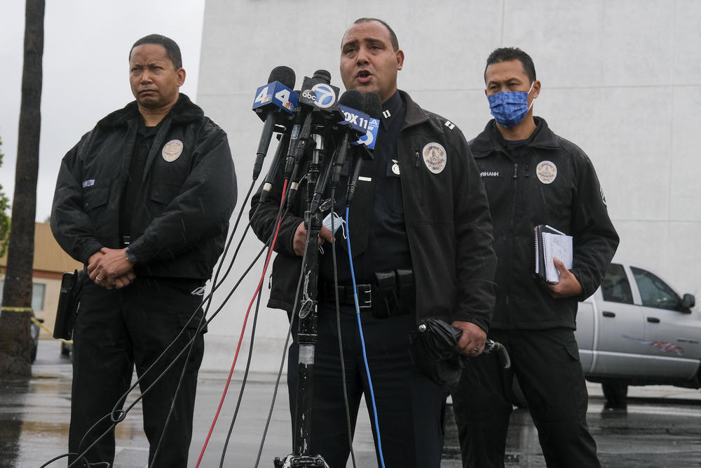 Los Angeles Police Department Capt. Stacy Spell (center) speaks at a news conference in December 2021. He says he has personally called journalists to improve relations.