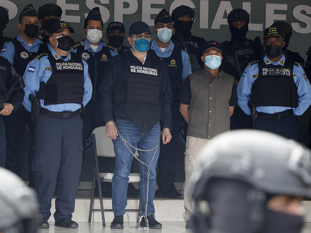 Former Honduran President Juan Orlando Hernández (center in chains), is shown to the press at the Police Headquarters in Tegucigalpa, Honduras, on Feb. 15.
