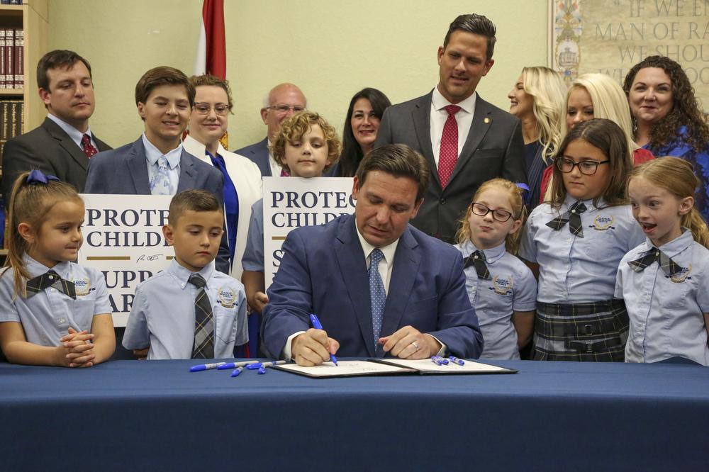 Florida Gov. Ron DeSantis signs the Parental Rights in Education bill at Classical Preparatory School in Spring Hill, Fla., on Monday, March 28, 2022.