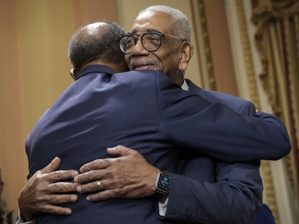 Rep. Bobby Rush, D-Ill., right, hugs radio host Joe Madison as they arrive for a bill enrollment ceremony for the Emmett Till Antilynching Act at the Capitol on March 16, 2022, after the House passed the legislation.