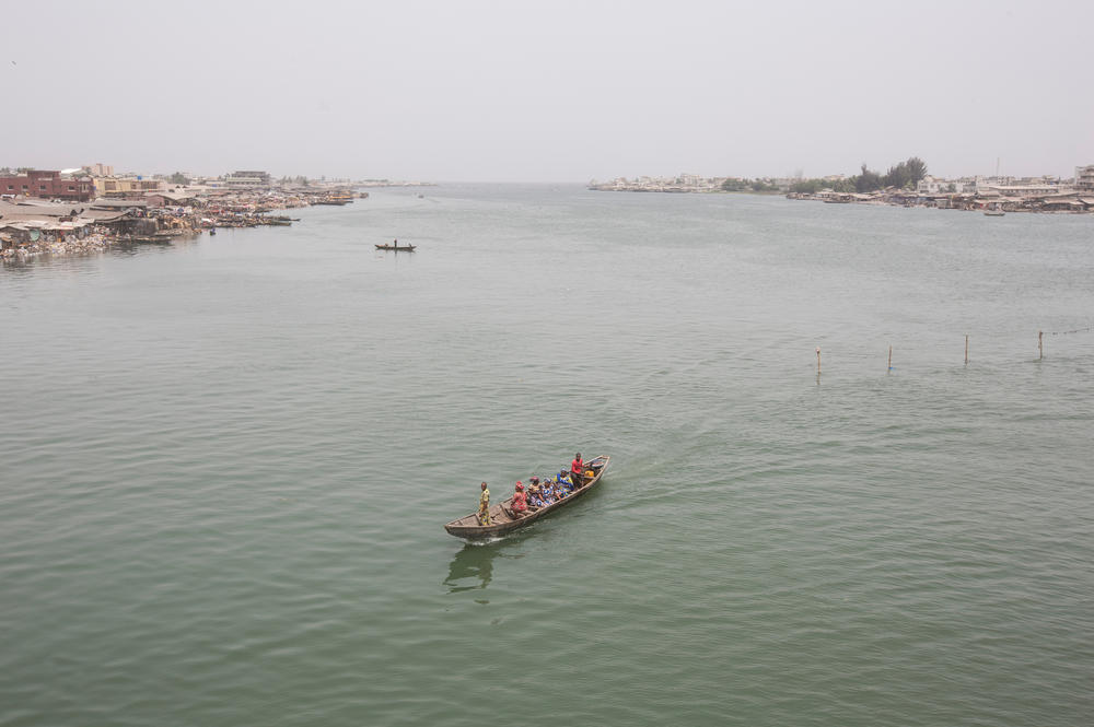 A passenger boat crosses a lagoon near Cotonou, Benin, on Feb. 23, 2016. Sea levels along the West African coast are expected to rise faster than the global average.