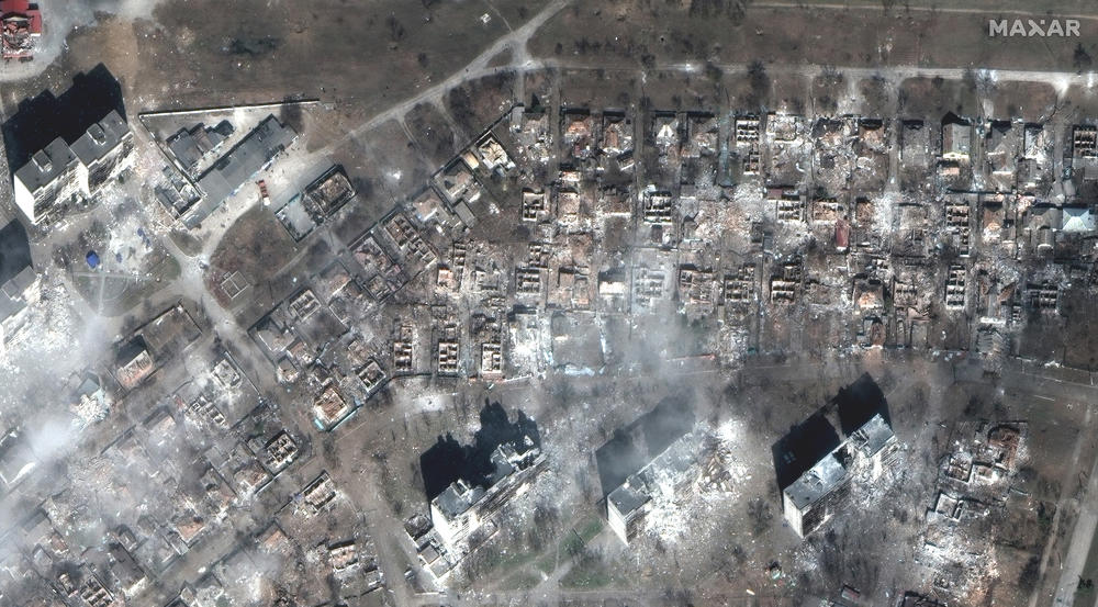 A satellite image shows apartment buildings and homes destroyed by shelling in Mariupol.