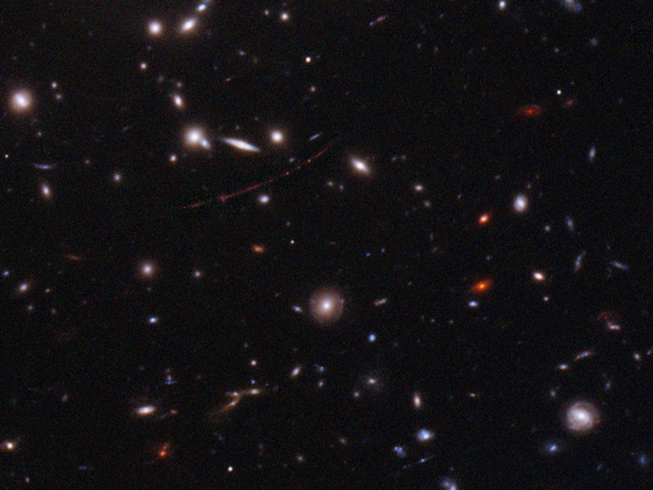 The Hubble Space Telescope has spotted the farthest star ever seen. The magnified galaxy looks like a stretched out red line with three dots. The single star is the middle one.