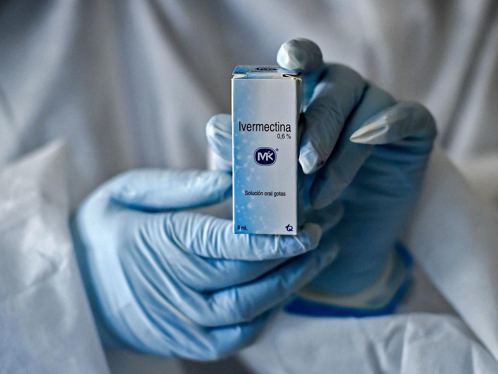 A health worker shows a box containing a bottle of Ivermectin in Cali, Colombia, on July 21, 2020.