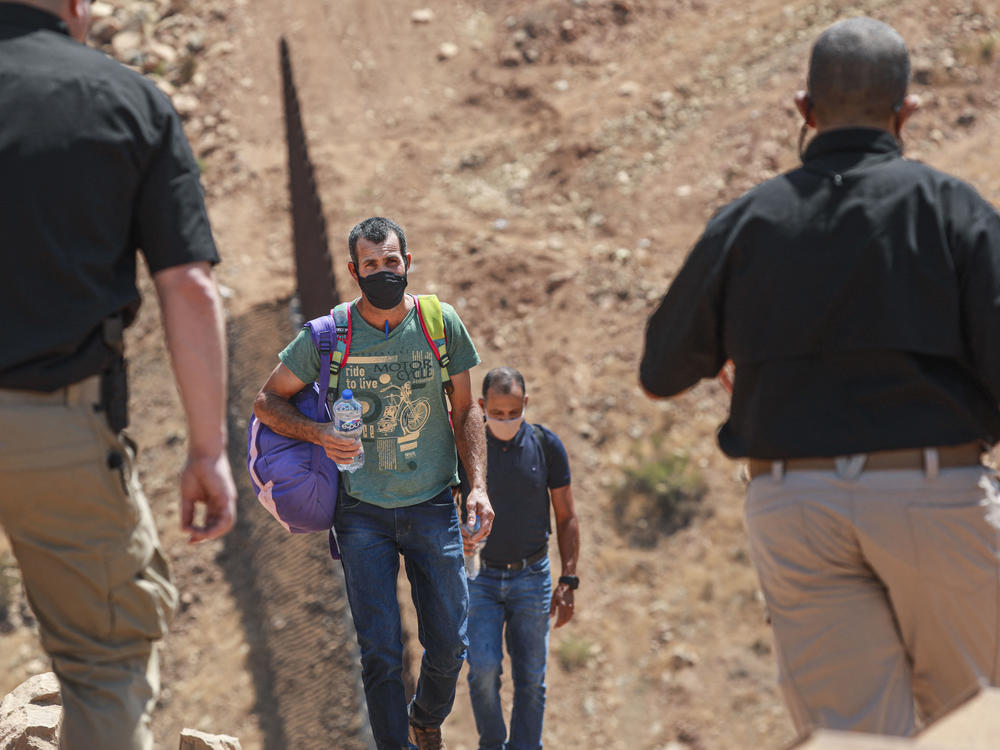 Customs and Border Protection agents apprehend a group of Brazilian migrants in Otay Mesa, Calif., in August 2021.