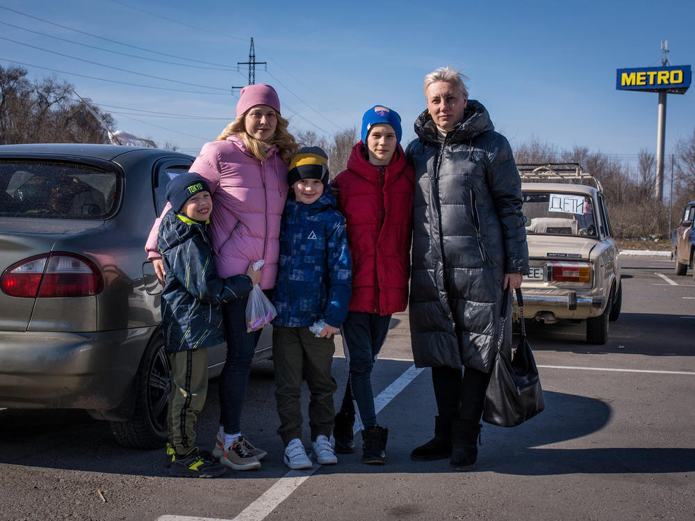 Angelina Voychenko (left) and her children and Yuliya Bortnik (right) and her son fled Mariupol after hiding for weeks in the basement of Voychenko's parents' home, with no electricity, phone service or heat, as the building shook from fighter jets and explosions. When they emerged to buy food, what they saw made them decide to leave: destroyed buildings, looted stores, no food in sight.