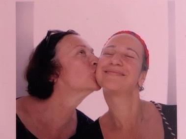 Vita Linnik (left) and Sofia Bretl smile and pose in a photo booth during happier times.