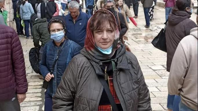 Vita Linnik stands on a street in Israel after evacuating from her home in Kharkiv, Ukraine.