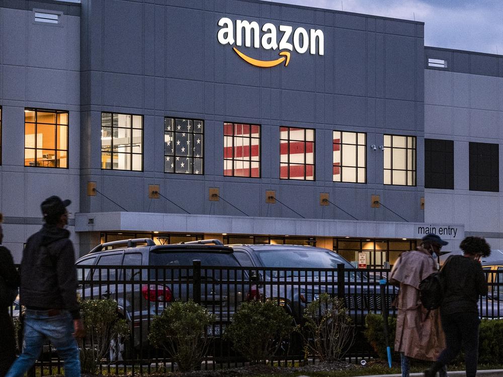 People arrive for work at the Amazon distribution center at the New York City borough of Staten Island on Oct. 25, 2021.