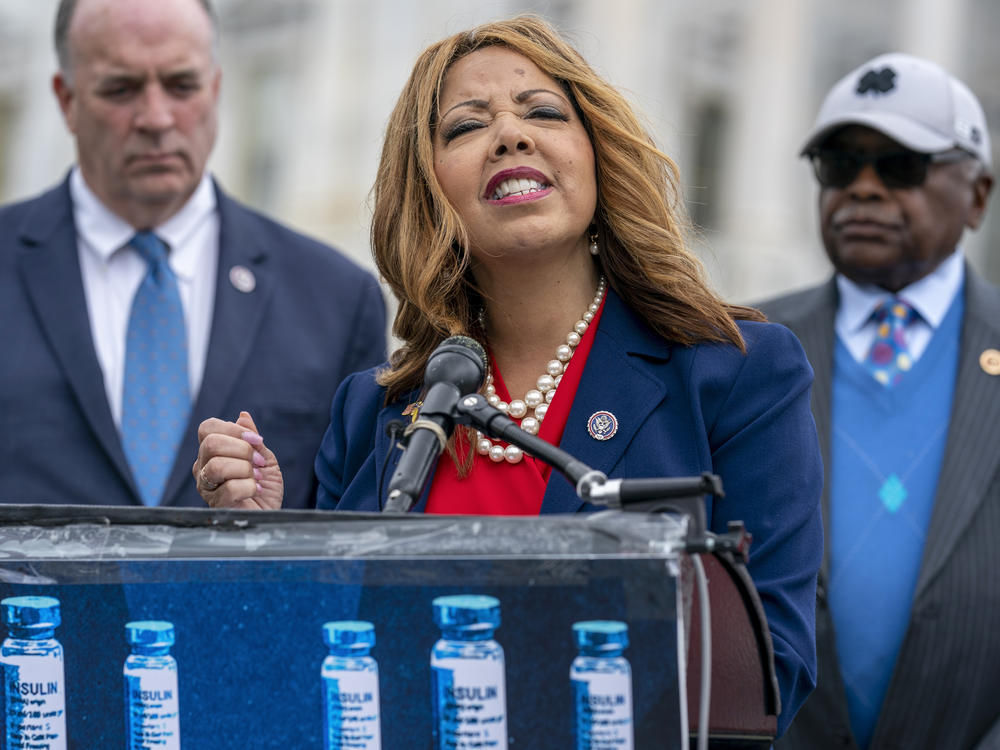 Rep. Lucy McBath, D-Ga., flanked by Rep. Dan Kildee, D-Mich., and House Majority Whip James Clyburn, D-S.C., speaks to reporters about a bill to cap the price of insulin at the Capitol on Thursday.