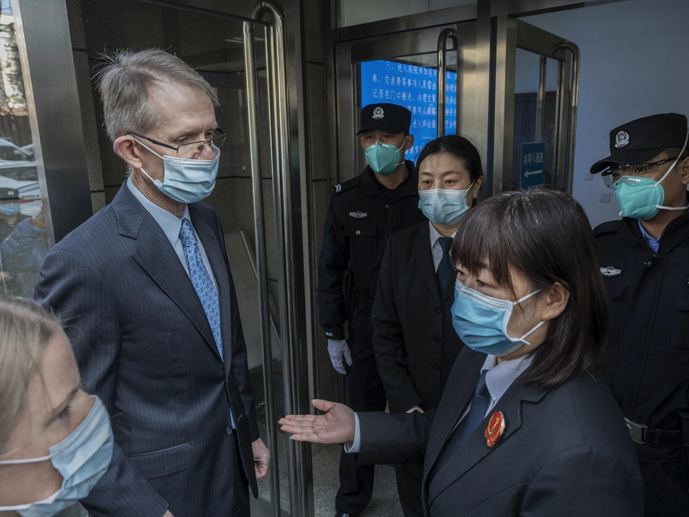 Australian Ambassador to China Graham Fletcher, left, is turned away by court officials and police as he tried to enter the trial of Chinese Australian journalist Cheng Lei at the Beijing Number 2 Intermediate People's Court on Thursday in Beijing.