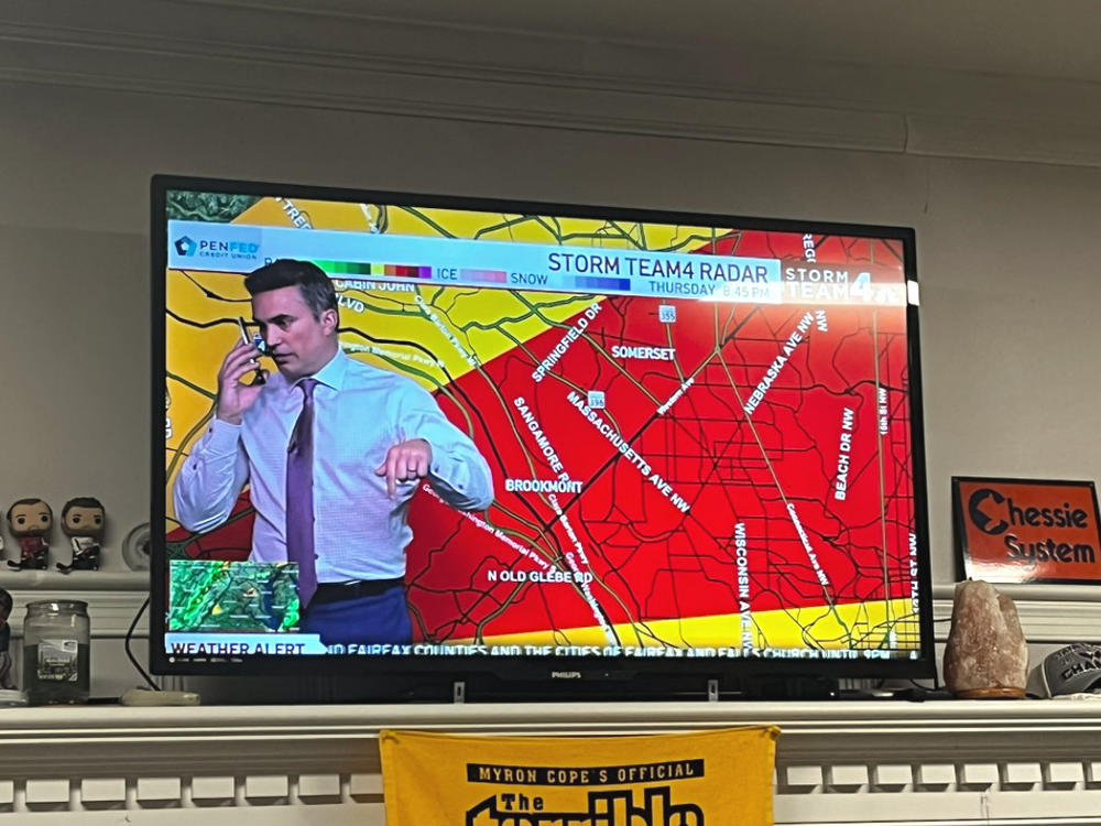 Meteorologist Doug Kammerer pauses his live weather broadcast to warn his family about a tornado warning.