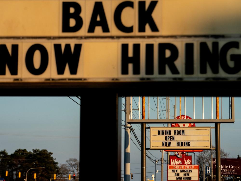 Signs with the message 'Now Hiring' are displayed in front of restaurants in Rehoboth Beach, Delaware, on March 19.