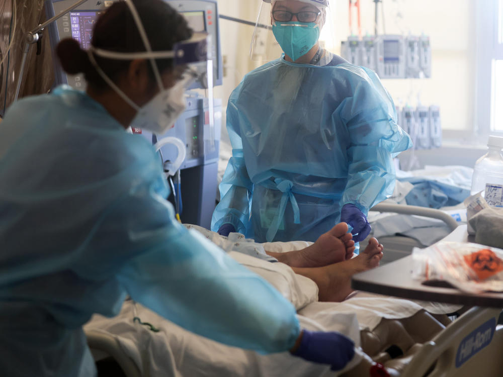 Healthcare workers care for COVID-19 patients in a makeshift ICU at Harbor-UCLA Medical Center on Jan. 21, 2021, in Torrance, Calif.