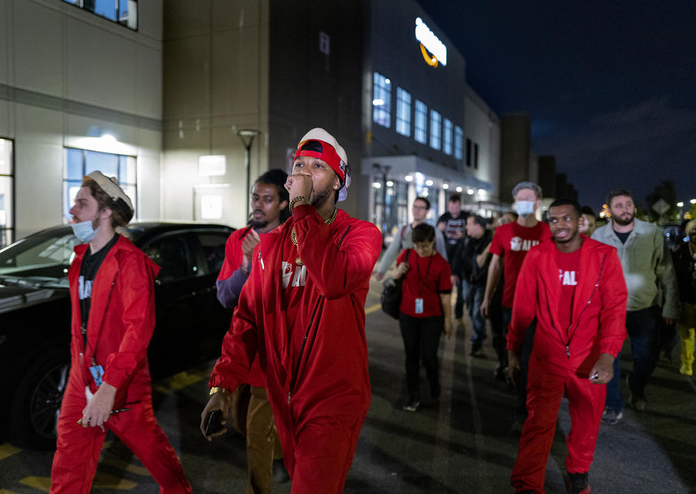 Chris Smalls (center), president of the Amazon Labor Union, joins supporters as they march and chant at the Amazon distribution center in Staten Island on Oct. 25, 2021.