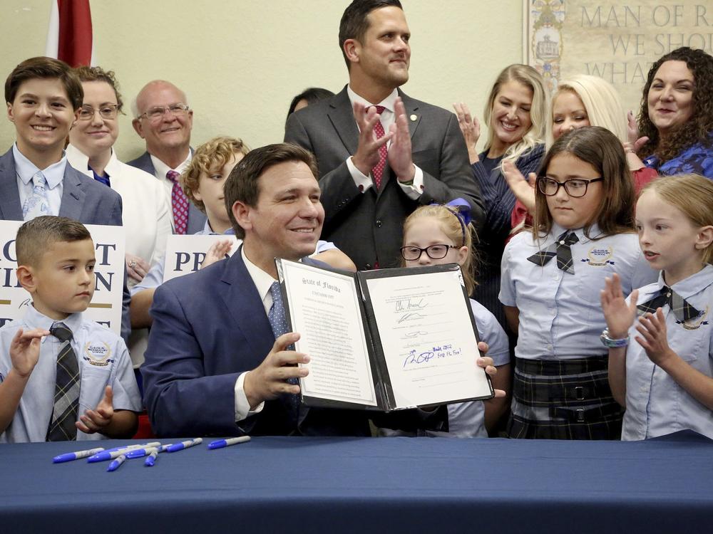 Florida Gov. Ron DeSantis displays the signed Parental Rights in Education, the so-called 
