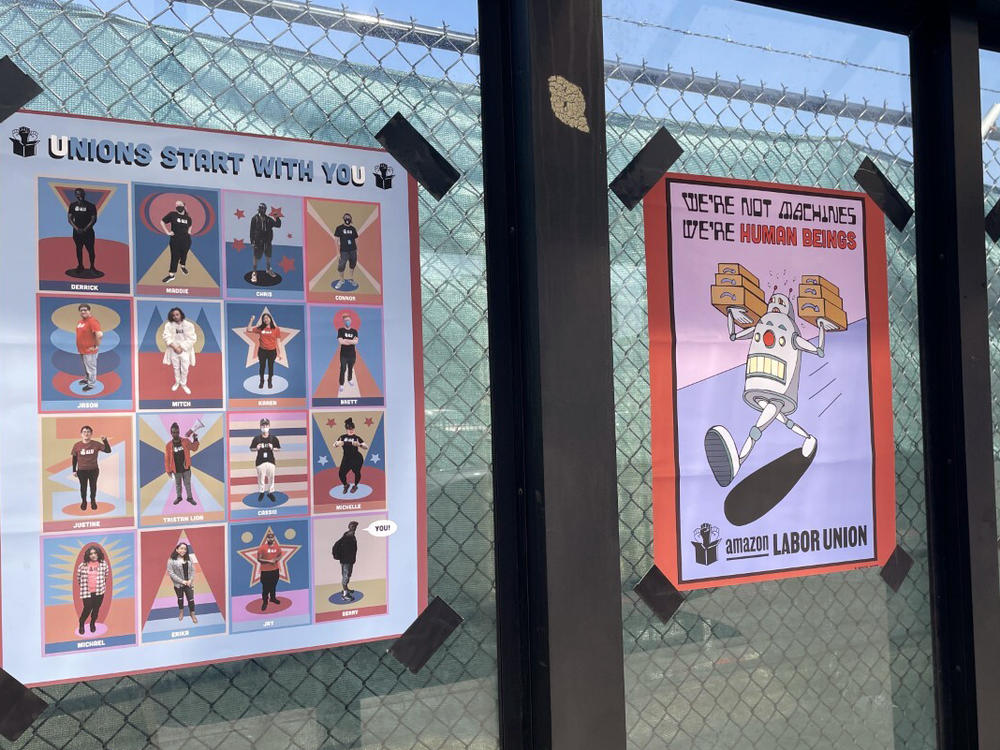 Signs are posted outside the the Amazon fulfillment center in Staten Island borough of New York at a bus stop on March 16.