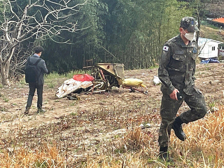 Debris from the South Korean Air force's KT-1 trainer aircraft collision are seen at a field in Sacheon, South Korea, Friday, April 1, 2022.