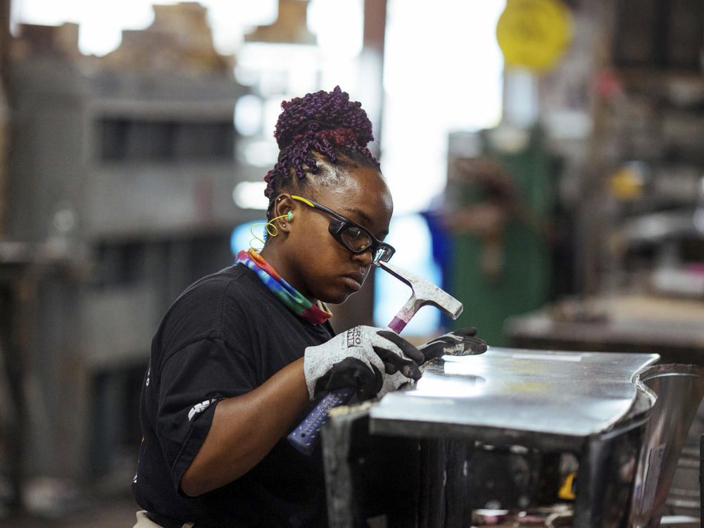 Sheet metal worker Carey Mercer assembles ductwork at Contractors Sheet Metal on Aug. 3, 2021, in New York. New York City and Washington, D.C., are among the cities in which young women earn more than young men, a Pew Research Center study found.