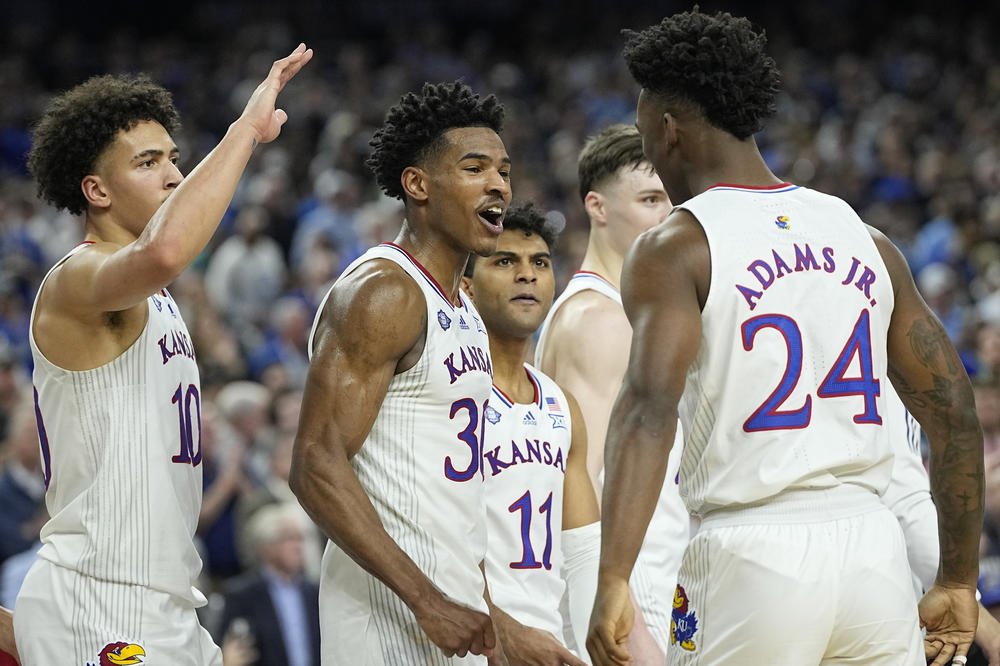 Kansas' Ochai Agbaji (30) celebrates with Jalen Wilson (10), Remy Martin (11) and K.J. Adams Jr. (24) after their win against Villanova in the semifinal round of the Men's Final Four NCAA tournament on Saturday in New Orleans.