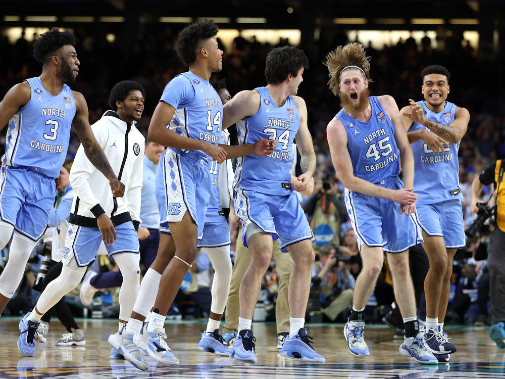 The North Carolina Tar Heels react after defeating the Duke Blue Devils 81-77 on Saturday, advancing to the final game of the 2022 NCAA Men's Basketball Tournament.