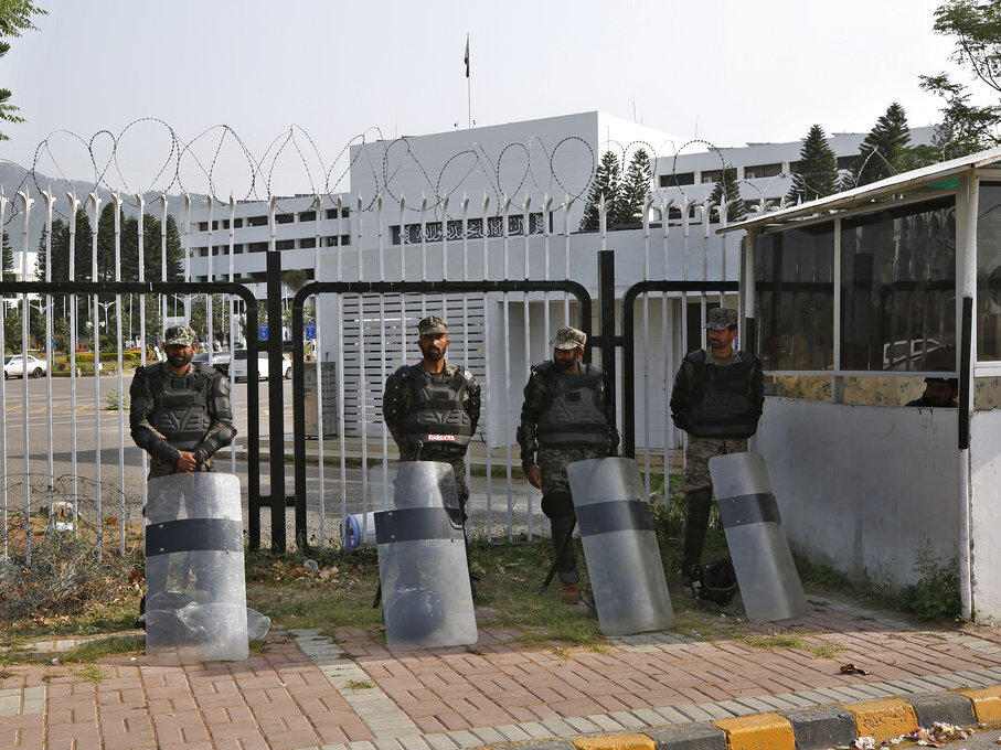 Pakistani paramilitary troops stand guard with riot gears outside the National Assembly, in Islamabad, Pakistan, Sunday, April 3, 2022.